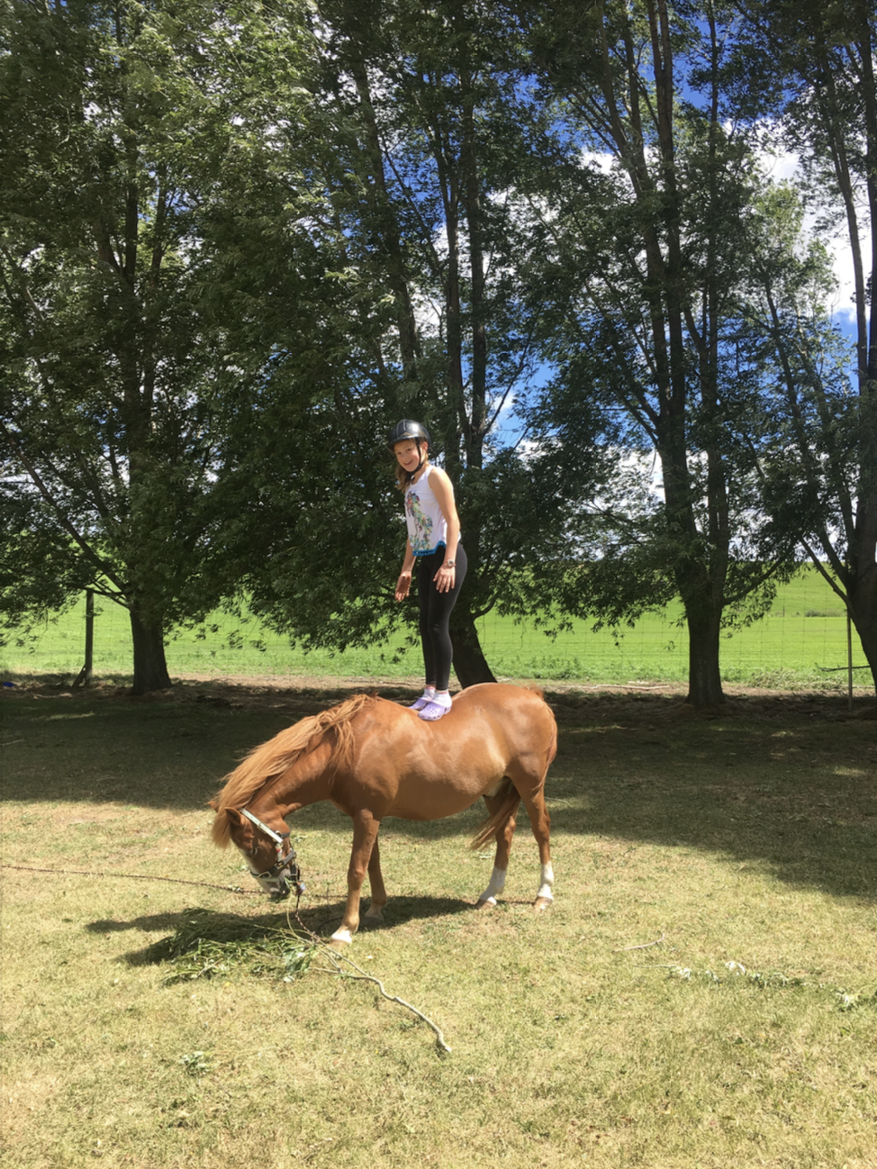 Nia on horseback in an open landscape